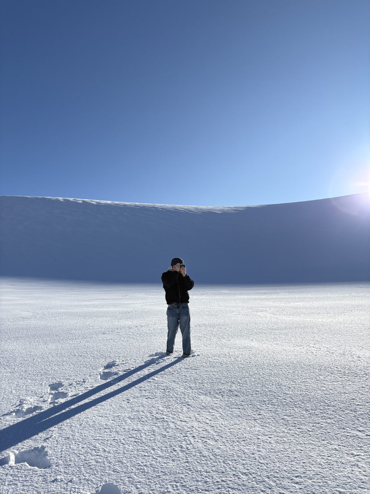 Joshua Busch out in the snow with a camera